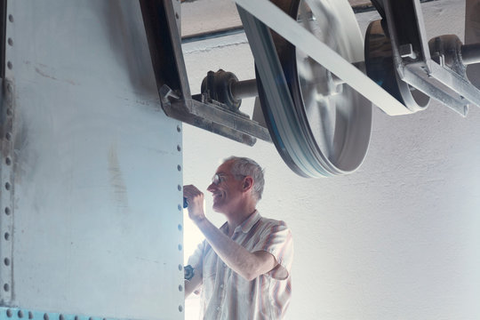 Male miller operating machine in wheat mill