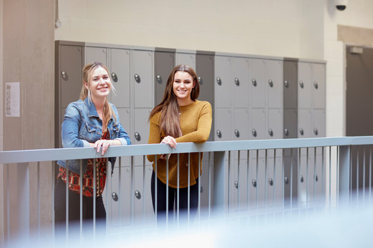 Portrait of two female students in higher education college locker room