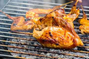 Grilled chicken on the flaming grill