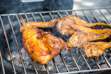 Grilled chicken on the flaming grill