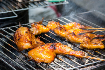 Grilled chicken on the flaming grill