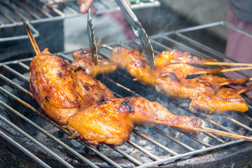 Grilled chicken on the flaming grill