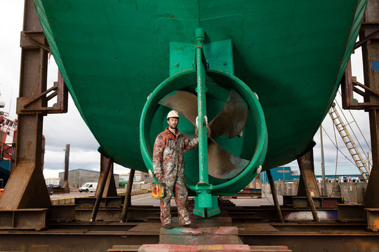 Worker standing in shipyard