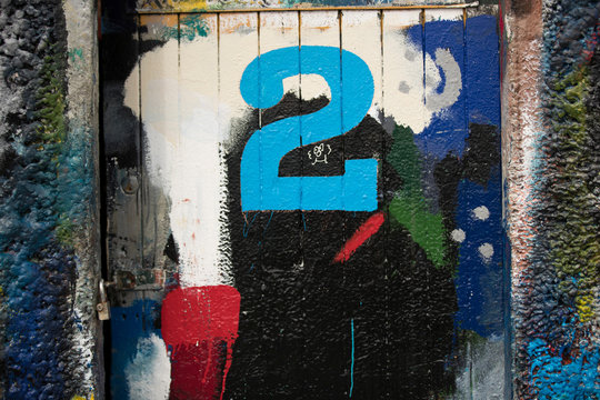 Number 2 door and paint covered wall in ship painters yard