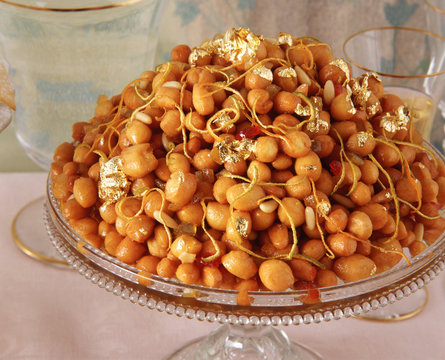 Traditional Italian party food, Cicerchiata, chick peas with gold leaf