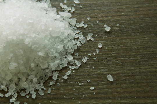 Close up of rock salt on wooden surface