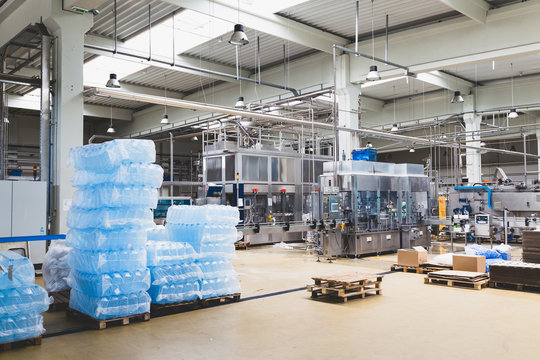 Industrial interiors. Robotic factory line for processing and quality control of pure spring water bottled into canisters. 