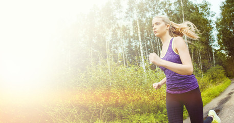 Obraz na płótnie Canvas Happy and healthy girl runner on the road, morning jog