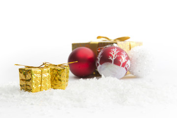Decorated Christmas gifts with balls in snow on white background