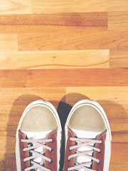 Fototapeta na wymiar Brand new sneakers on a wooden floor.