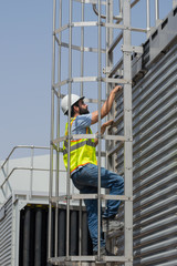 Mechanical engineer during a site visit, checking cooling towers installation