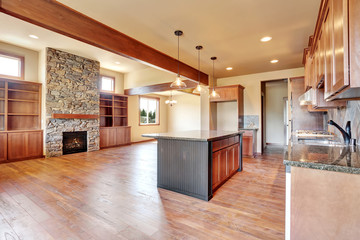 Kitchen room with wooden cabinets, island and granite counter top