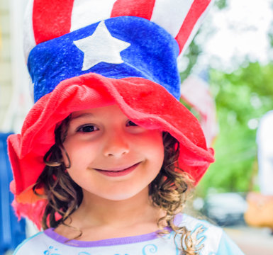Portrait of cute girl wearing stars and stripes hat on Independence Day