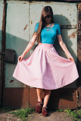 Beautiful fashionable young woman in pink dress