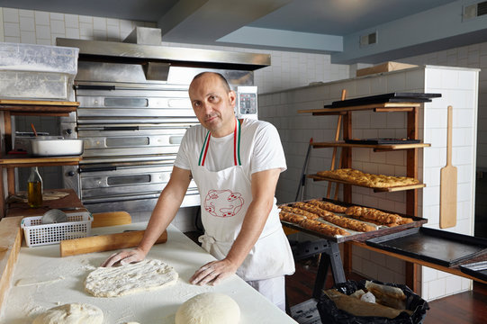 Portrait of male baker preparing dough 
