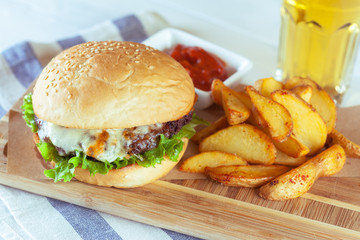 burger and french fries on wooden table