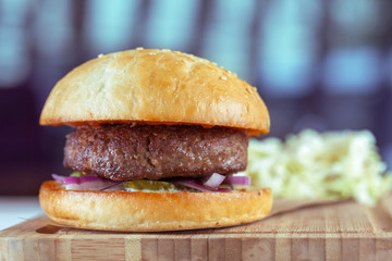 home made burgers on wooden background