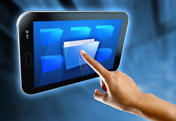 A woman's finger select a folder on a digital tablet