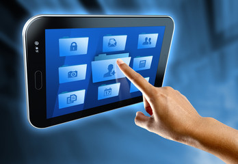 A woman's finger select a folder on a digital tablet