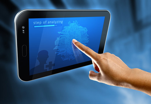 A woman's finger scanning her fingerprints. on a digital tablet