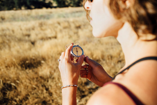 Over shoulder view of woman using compass