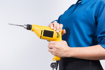 Young builder woman with a drill