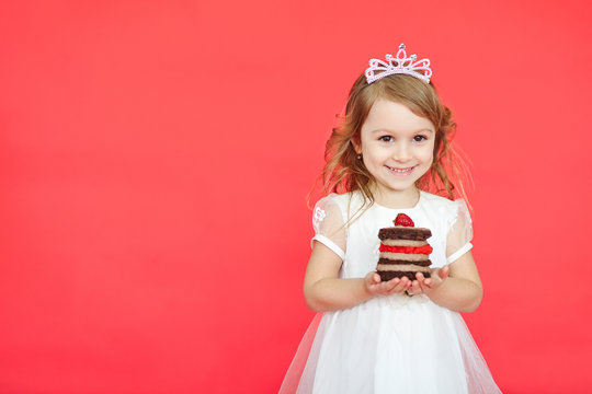 cute little girl and her birthday cake on red background