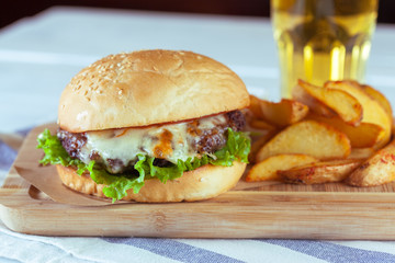 burger and french fries on wooden table