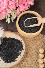 Poppy seeds of organic on wood background.