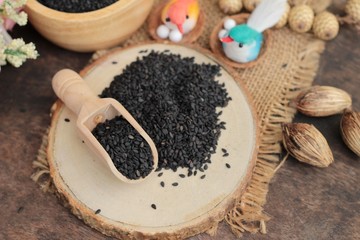 Poppy seeds of organic on wood background.