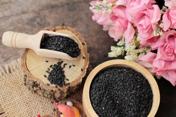 Poppy seeds of organic on wood background.