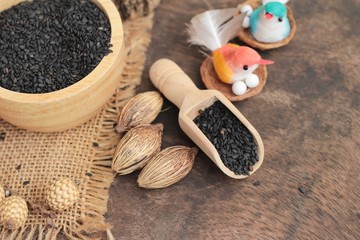 Poppy seeds of organic on wood background.