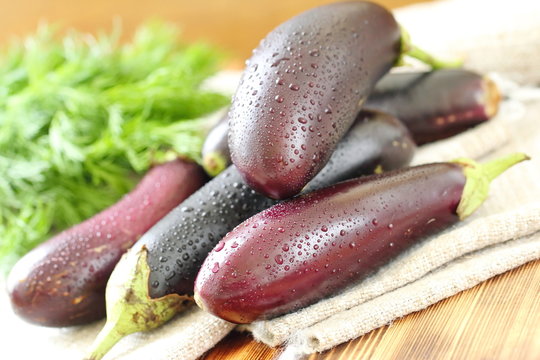 Fresh eggplants on chopping board
