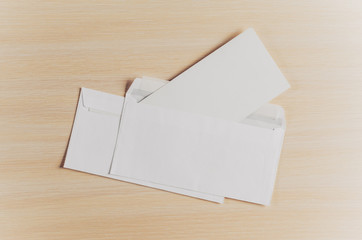 Blank envelopes on a wooden background