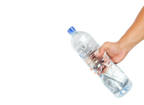 Hand holding a bottle of water. Motion in drinking water.