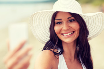 young woman taking selfie with smartphone