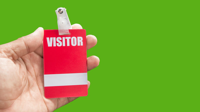 holding visitor card