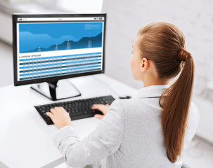 businesswoman with graphs on computer at office