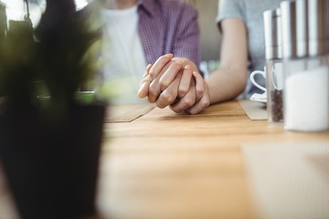 Mid-section of couple holding hands
