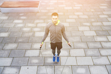 man exercising with jump-rope outdoors