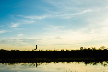 silhouette man jogging on the sunset background
