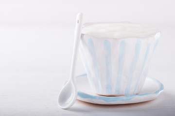 Yogurt,homemade in a ceramic bowl  on a white background.Breakfast.Healthy food or diet concept.selective focus.