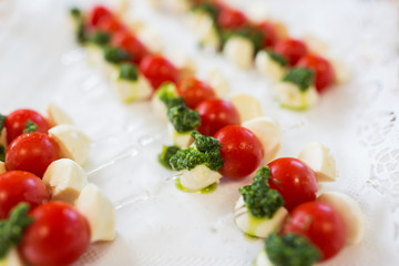 close up of mozzarella and cherry tomato canape