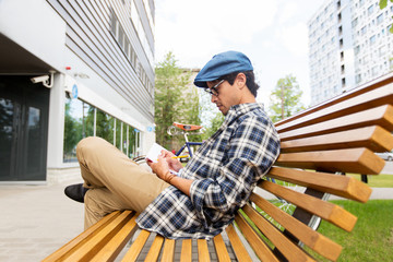 man with notebook or diary writing on city street