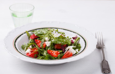 Salad of fresh strawberries,arugula,lettuce,cheese and sesame seeds .healthily cooking concept.selective focus.