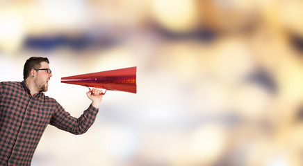 Hipster man shout in trumpet . Mixed media