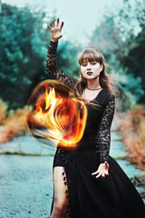 Powerful witch with fireball in hands
