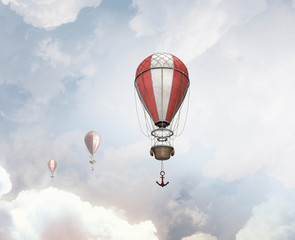 Aerostats flying over sky . Mixed media