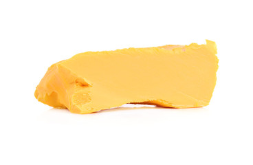 Stick of butter, cut, isolated on white.