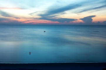 beautiful sunrise sunset with fishing boat in the sea